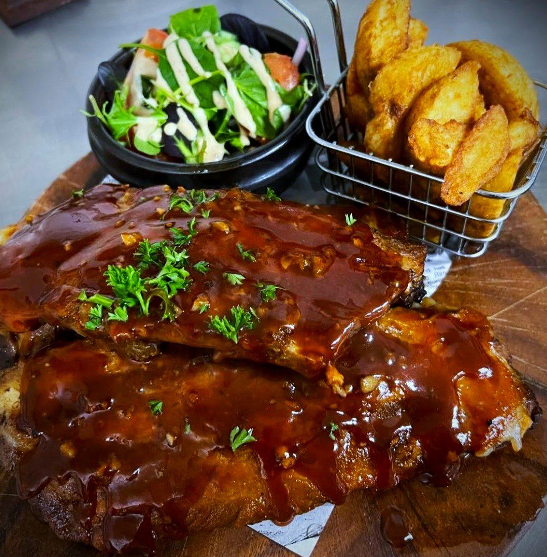 BBQ pork ribs with wedges and salad